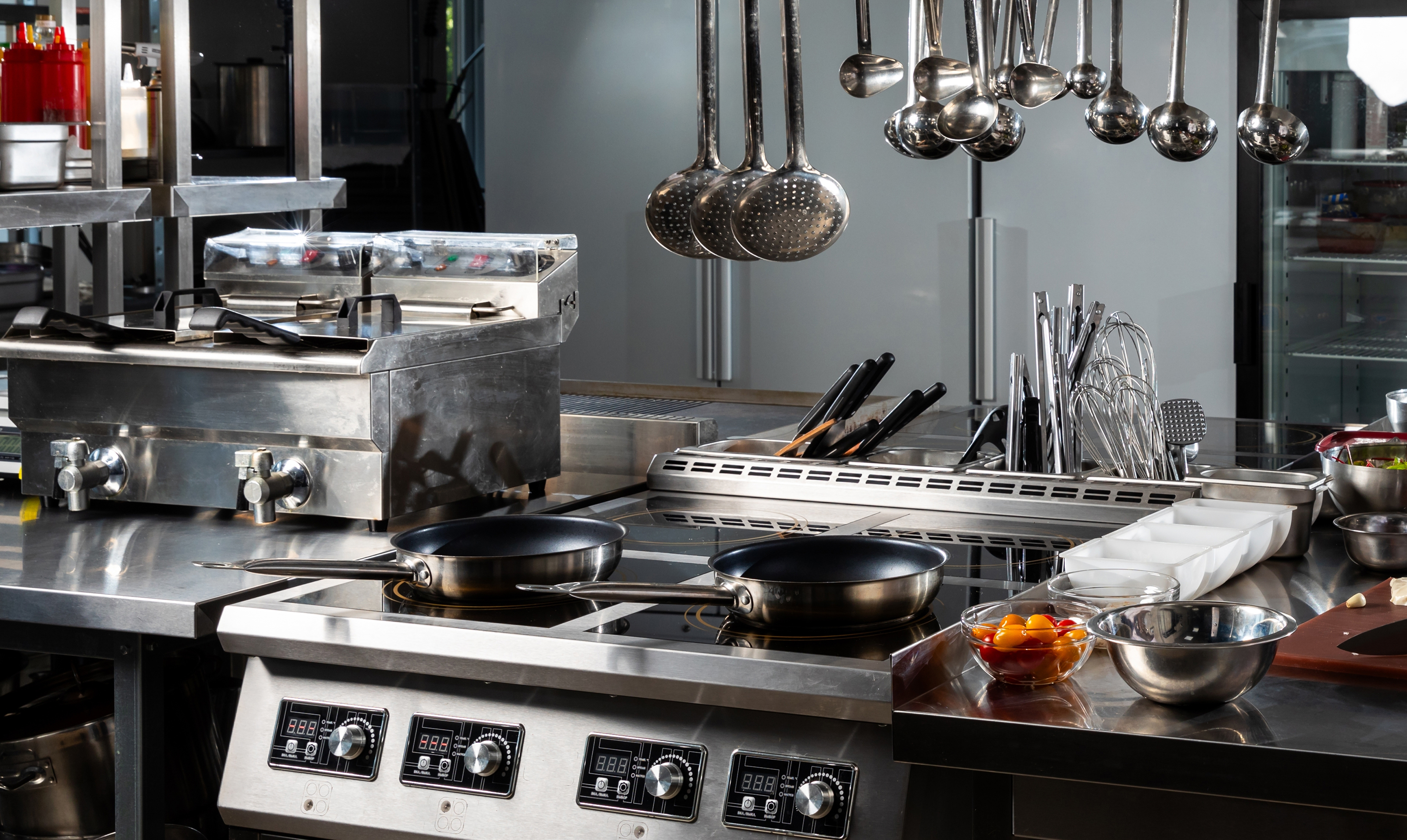 Commercial induction cooktop and cooking equipment in a professional kitchen